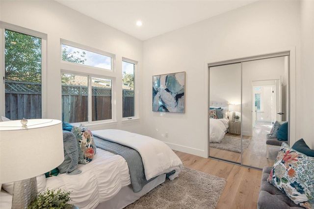 a bedroom with a bed and a large window