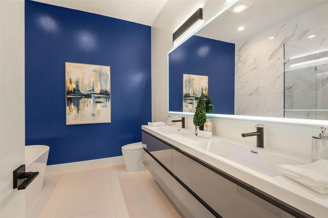 a bathroom with a sink a mirror and a vanity