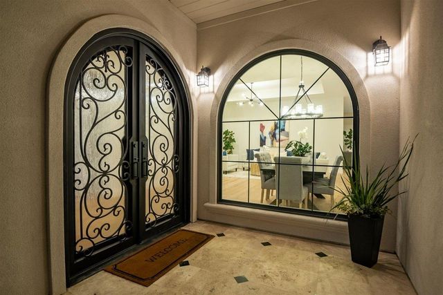 a view of entrance gate with wooden floor and a potted plant