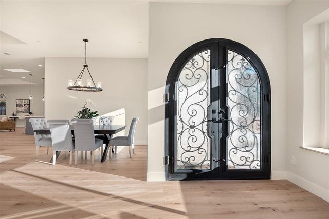 a view of a hallway with entryway dining table and paintings on the wall