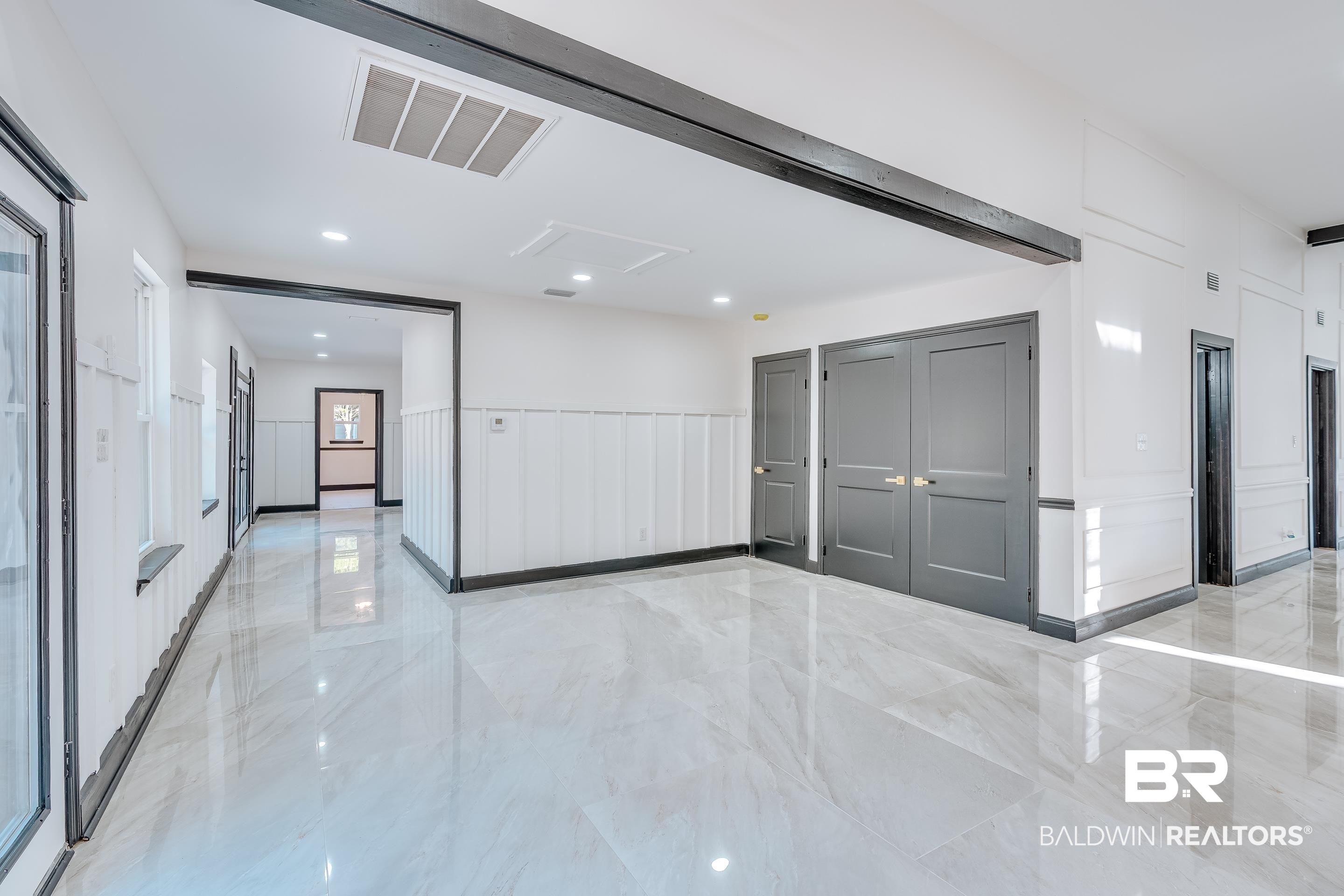 1190 Military Road Mount Vernon, AL 36560 - Photo 17 of 47 Spare room with light marble finish flooring, recessed lighting, attic access, and a decorative wall