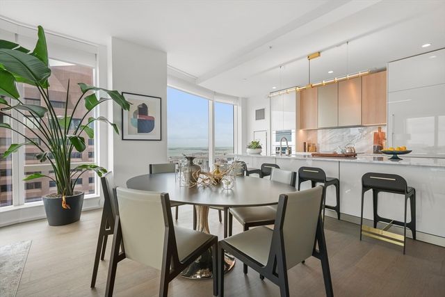 a view of a dining room with furniture and a potted plant