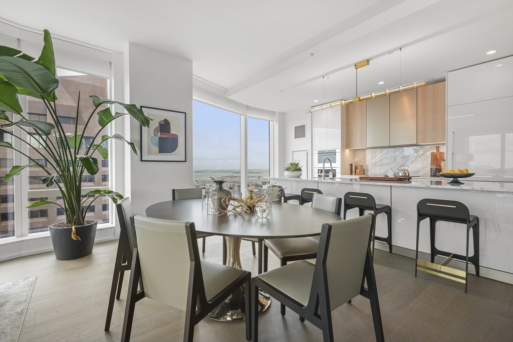 240 Devonshire Street, Unit 5612 Boston, MA 02110 - Photo 2 of 42 a view of a dining room with furniture and a potted plant
