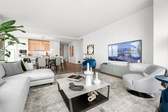 a living room with furniture a rug and a window
