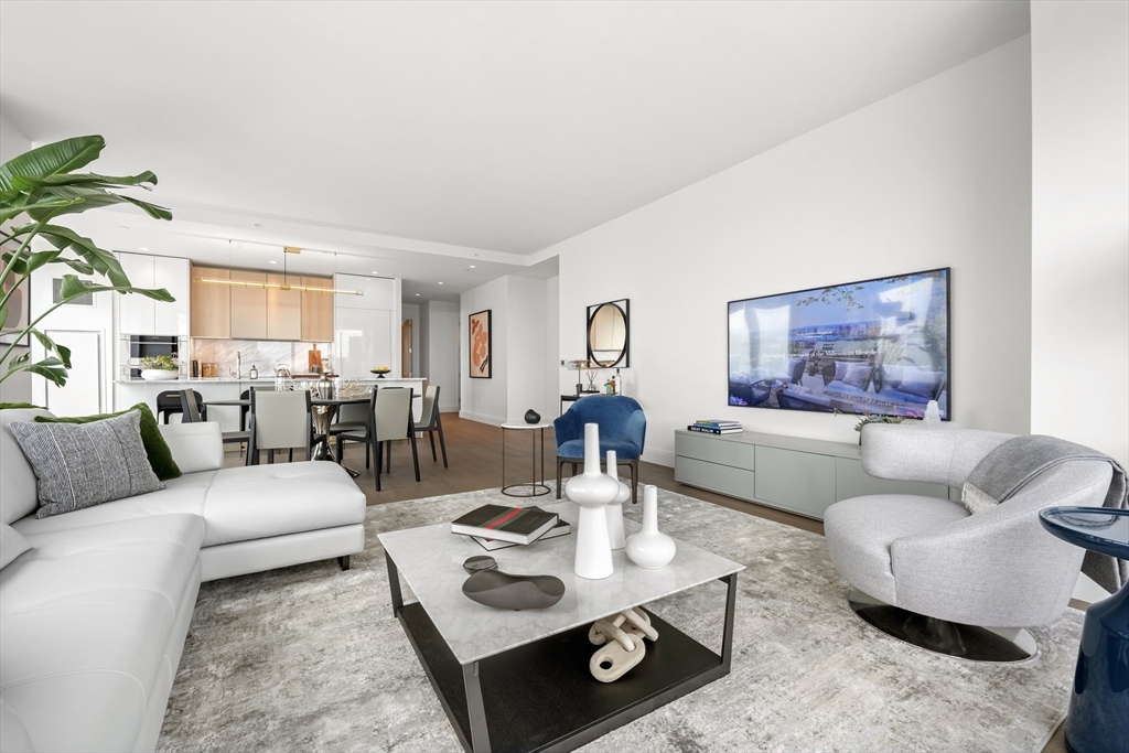 240 Devonshire Street, Unit 5612 Boston, MA 02110 - Photo 4 of 42 a living room with furniture a rug and a window