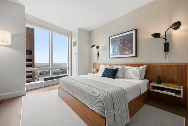 a bedroom with a large bed and a large window