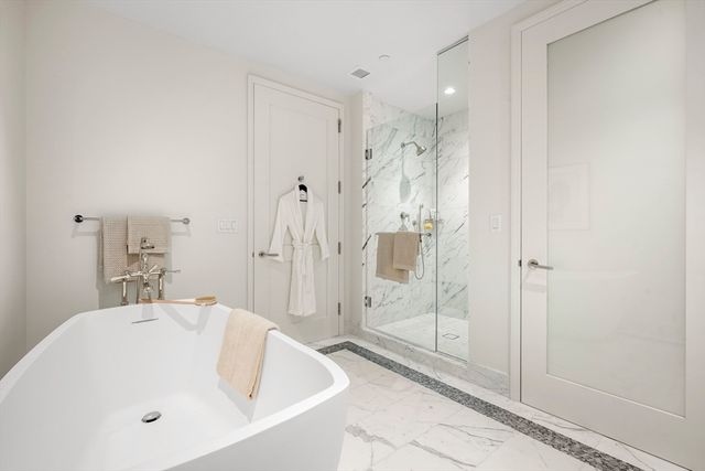 a bathroom with a bathtub and shower