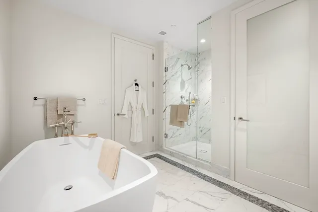a bathroom with a bathtub and shower