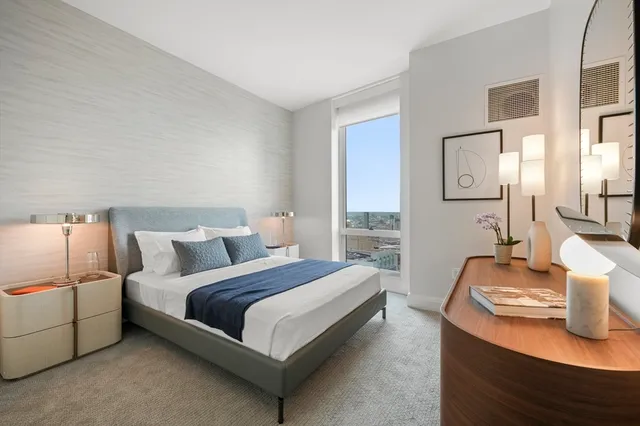 a bedroom with a bed and lamp