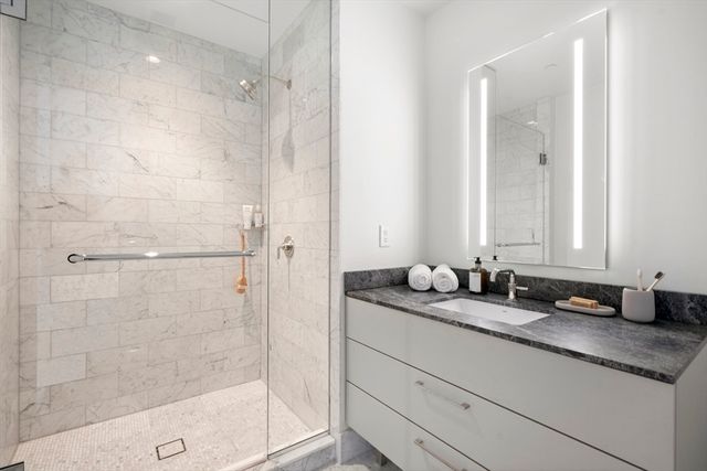 a bathroom with a granite countertop sink mirror and double