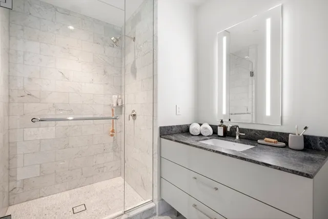 a bathroom with a granite countertop sink mirror and double