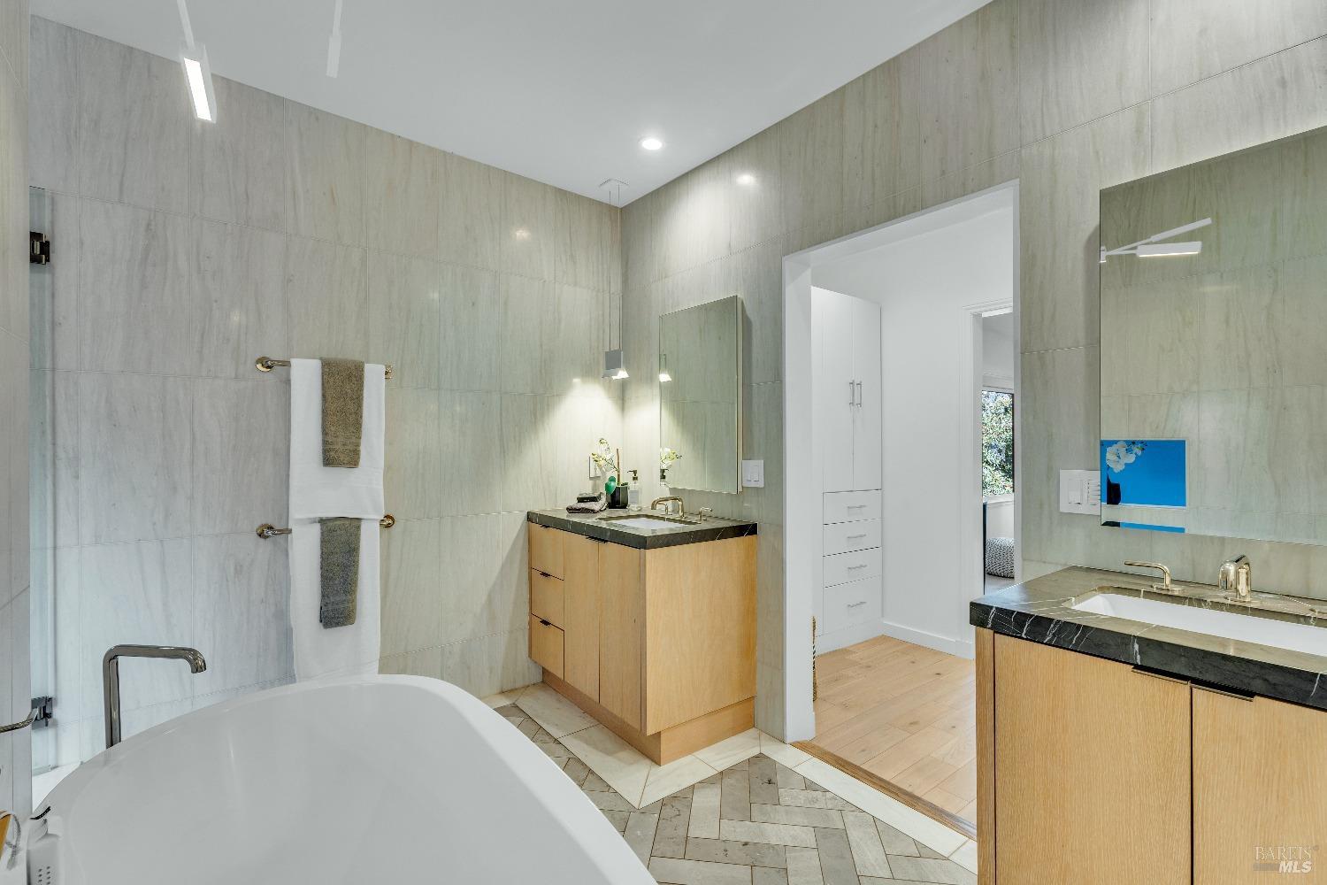 30 Bella Vista Avenue Belvedere, CA 94920 - Photo 32 of 89 a bathroom with a granite countertop sink a mirror and shower