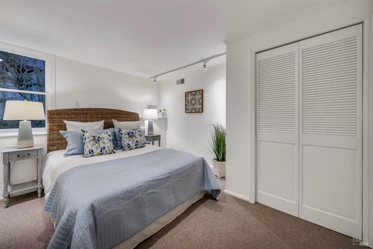 30 Bella Vista Avenue Belvedere, CA 94920 - Photo 44 of 89 a bedroom with a bed and a potted plant