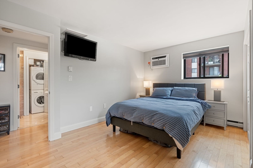 135 Franklin Street, Unit 101 Stoneham, MA 02180 - Photo 11 of 24 a bedroom with a bed and a flat screen tv