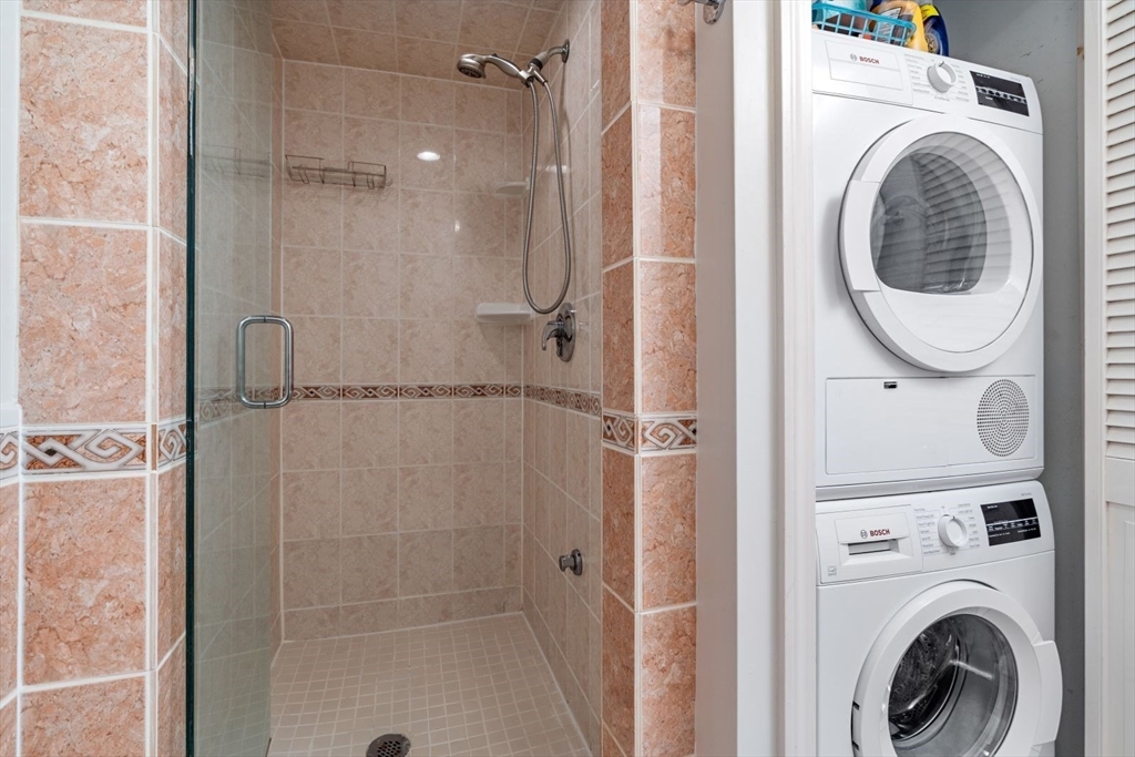 135 Franklin Street, Unit 101 Stoneham, MA 02180 - Photo 18 of 24 a bathroom with a shower and a view of bathroom
