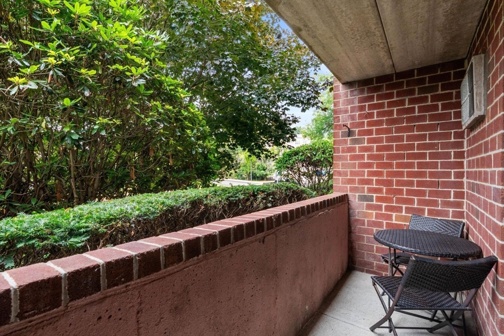 135 Franklin Street, Unit 101 Stoneham, MA 02180 - Photo 19 of 24 a view of a chair and table in the balcony