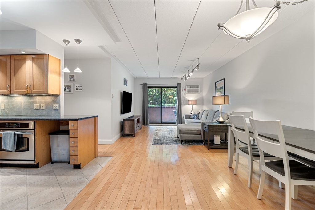 135 Franklin Street, Unit 101 Stoneham, MA 02180 - Photo 5 of 24 a living room with furniture and a wooden floor