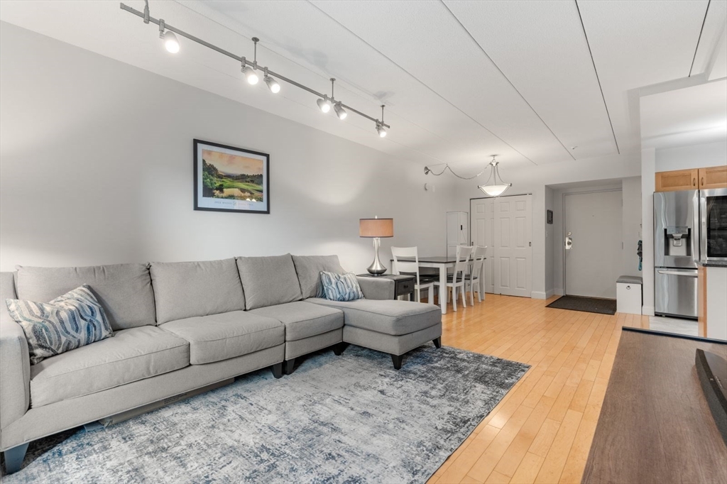 135 Franklin Street, Unit 101 Stoneham, MA 02180 - Photo 9 of 24 a living room with furniture and kitchen view