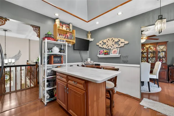 a kitchen with a stove a refrigerator and a dining table