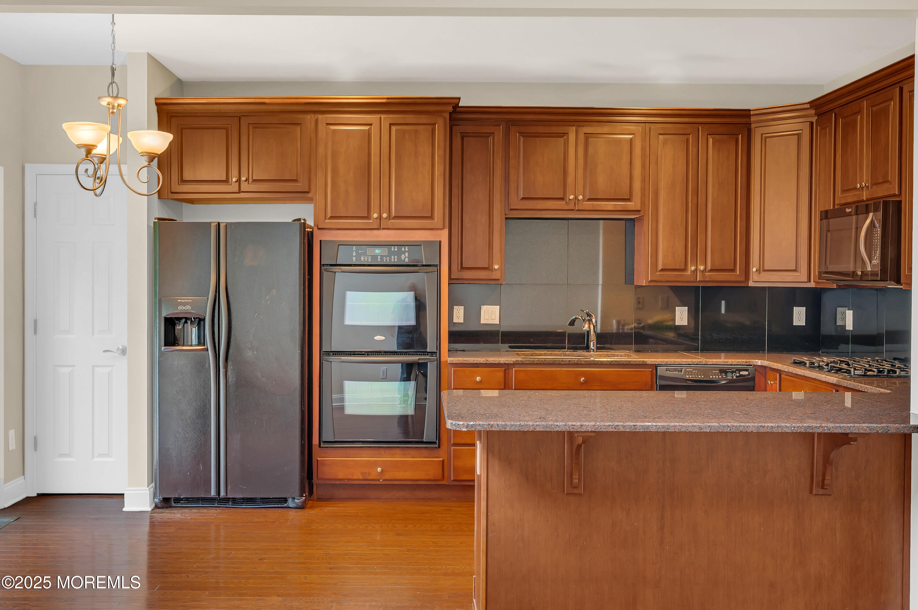59 Brookfield Drive Jackson, NJ 08527 - Photo 12 of 42 a view of a kitchen with granite countertop wooden cabinets and a refrigerator