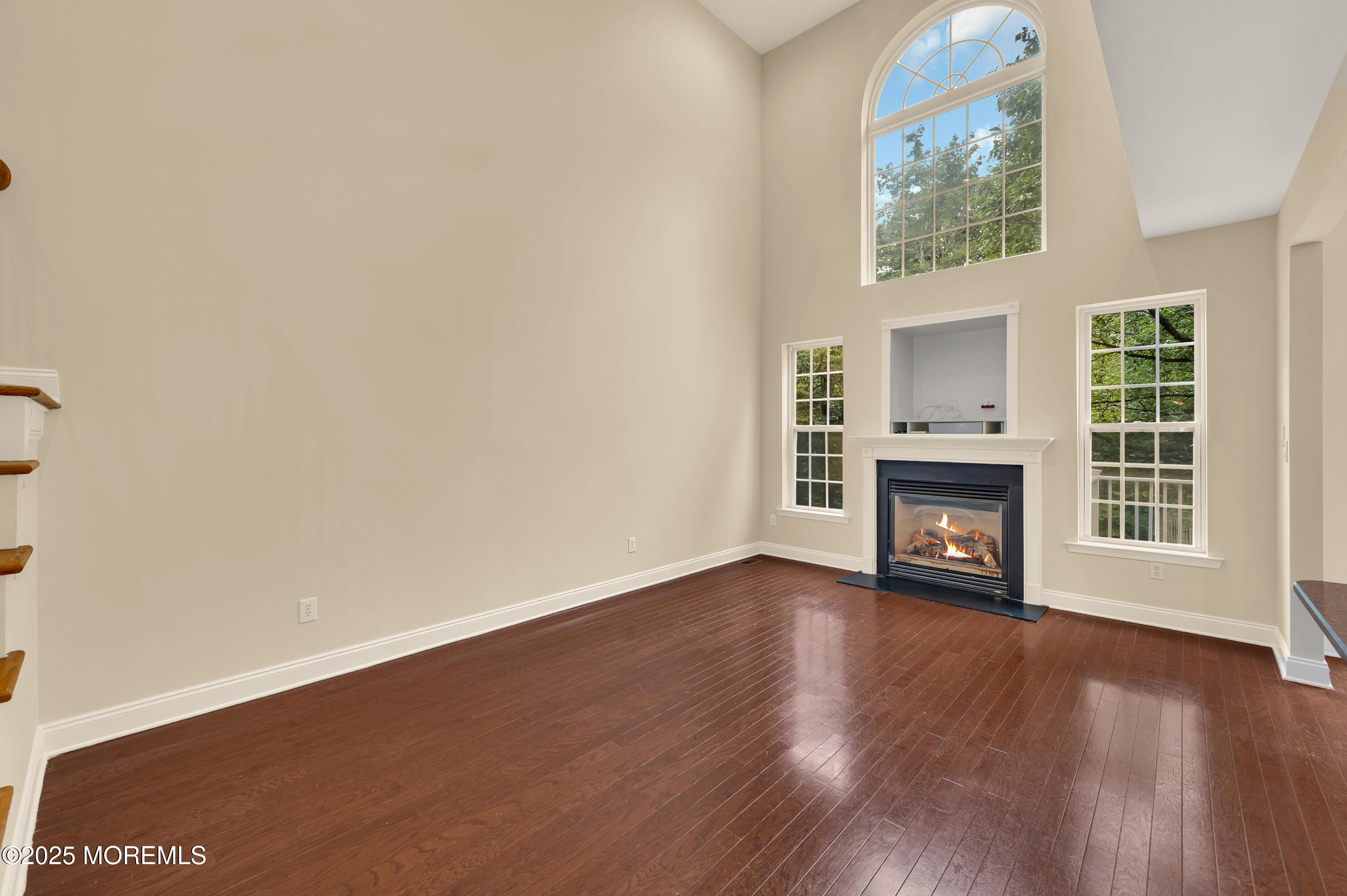 59 Brookfield Drive Jackson, NJ 08527 - Photo 19 of 42 an empty room with wooden floor fireplace and windows
