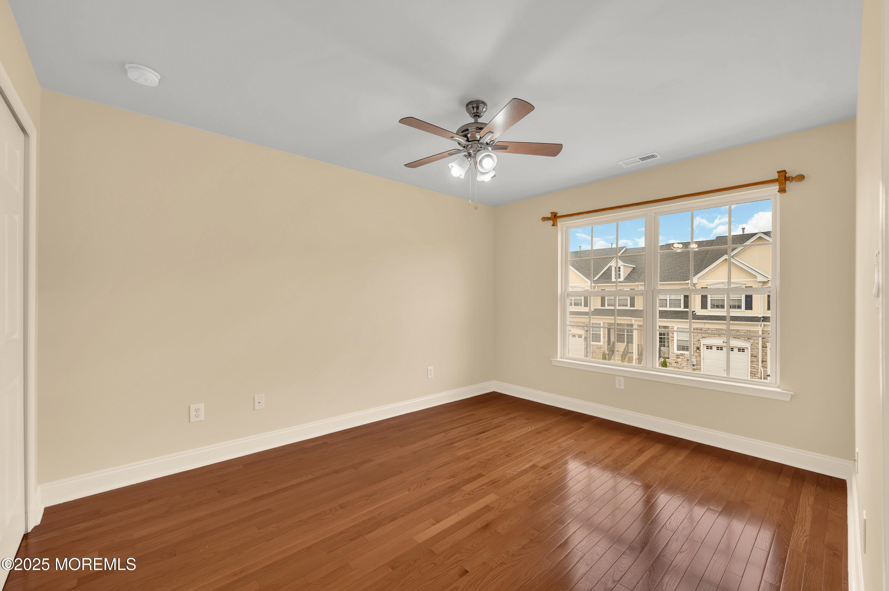 59 Brookfield Drive Jackson, NJ 08527 - Photo 22 of 42 a view of an empty room with a window and wooden floor