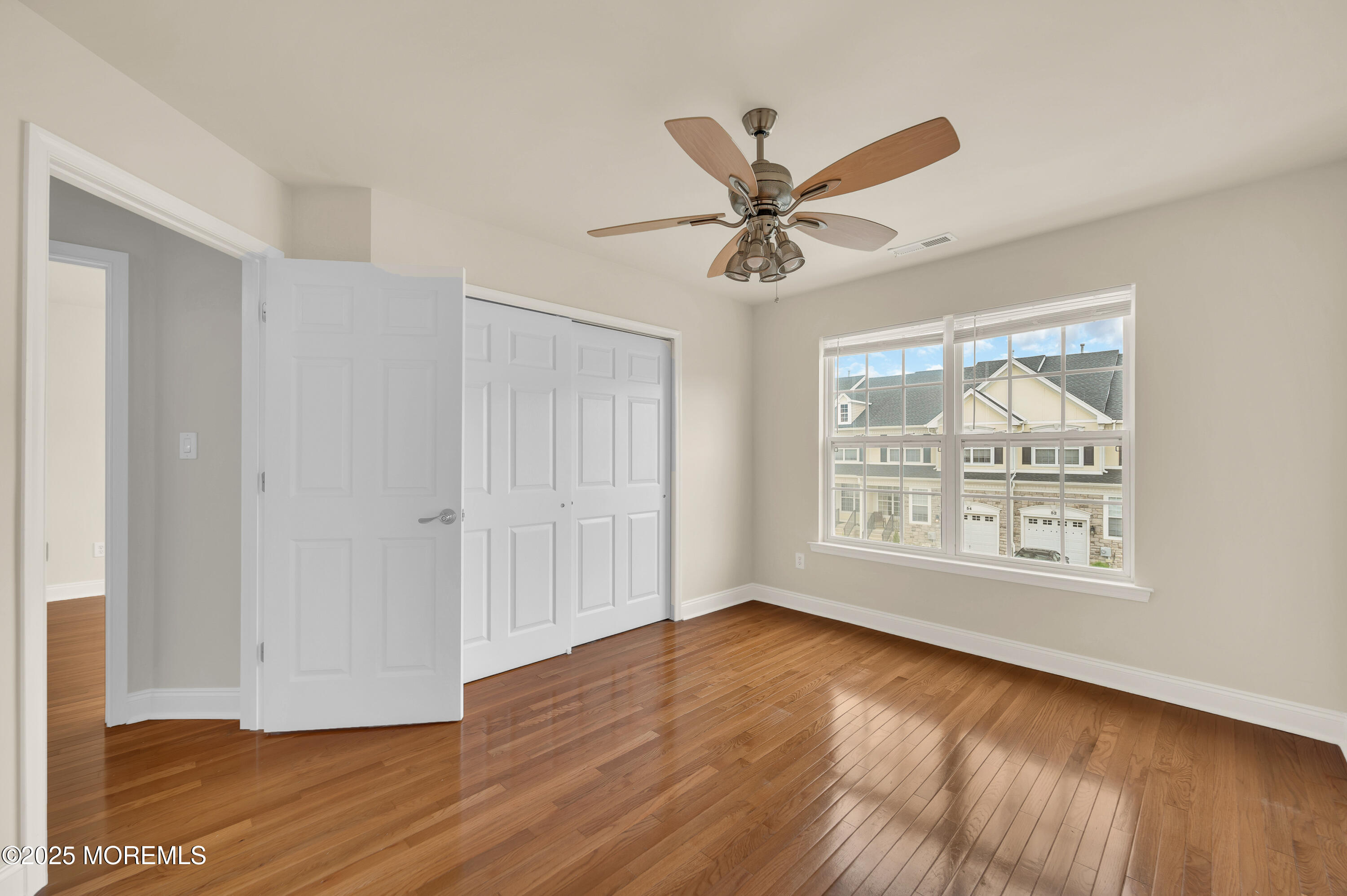 59 Brookfield Drive Jackson, NJ 08527 - Photo 24 of 42 a view of an empty room with wooden floor and a window