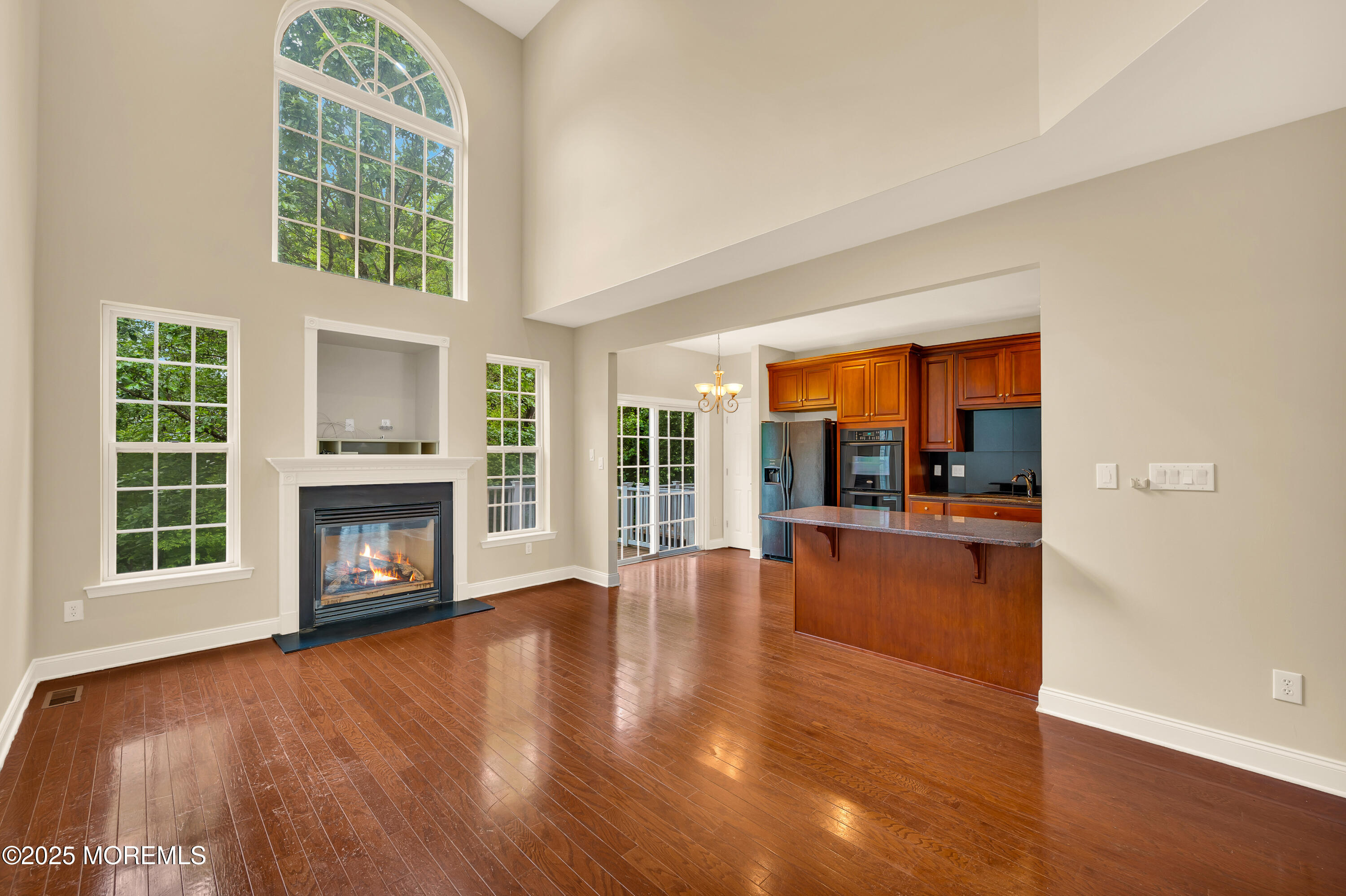 59 Brookfield Drive Jackson, NJ 08527 - Photo 10 of 42 wooden floor fireplace and windows in an empty room