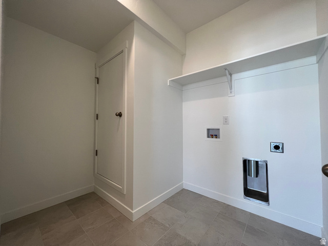 717 West W Coho Lane South, Unit 2F302 Midvale, UT 84047 - Photo 15 of 22 Laundry area featuring tile flooring, a built-in storage shelf, and utility hookups