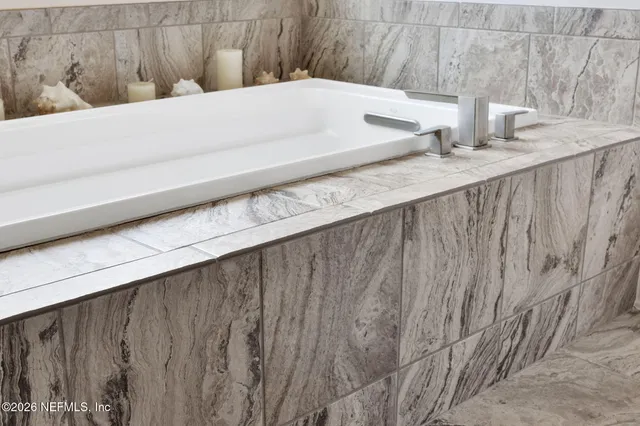 an aerial view of residential building with outdoor space and trees