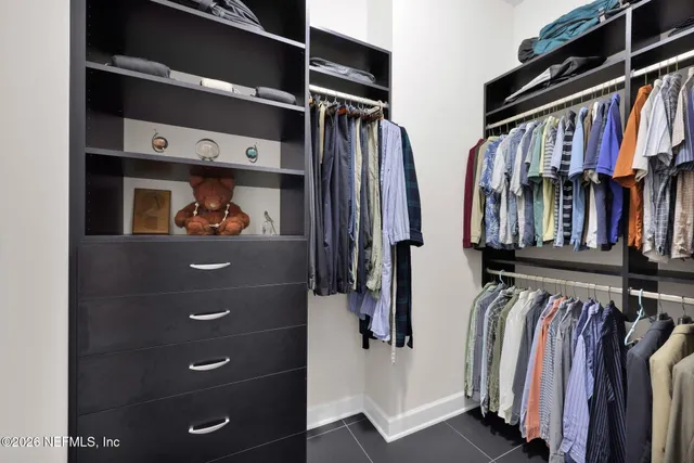 an aerial view of residential houses with outdoor space and ocean view