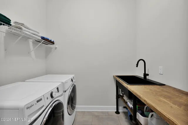 an aerial view of residential houses with outdoor space and swimming pool