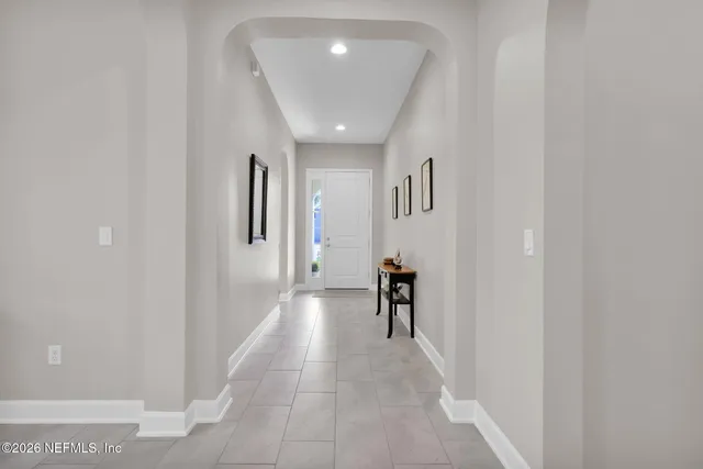 a view of a dining room with furniture and a potted plant