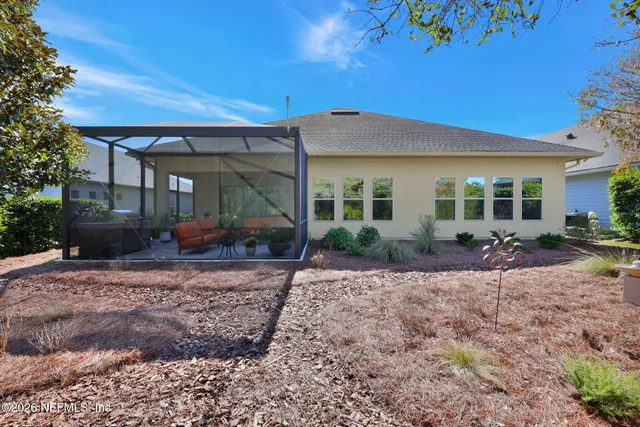 a view of a swimming pool with lawn chairs under an umbrella