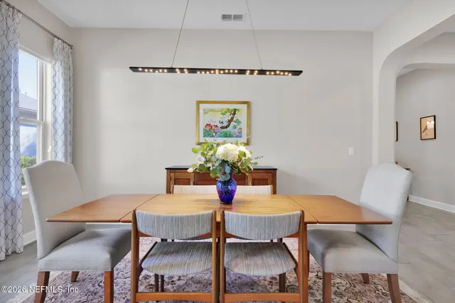a living room with furniture and a view of kitchen