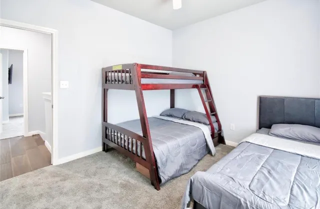 a bedroom with two beds and white walls