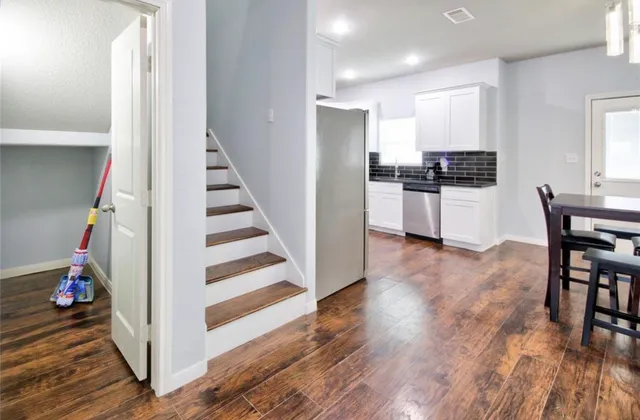 a view of a kitchen and wooden floor