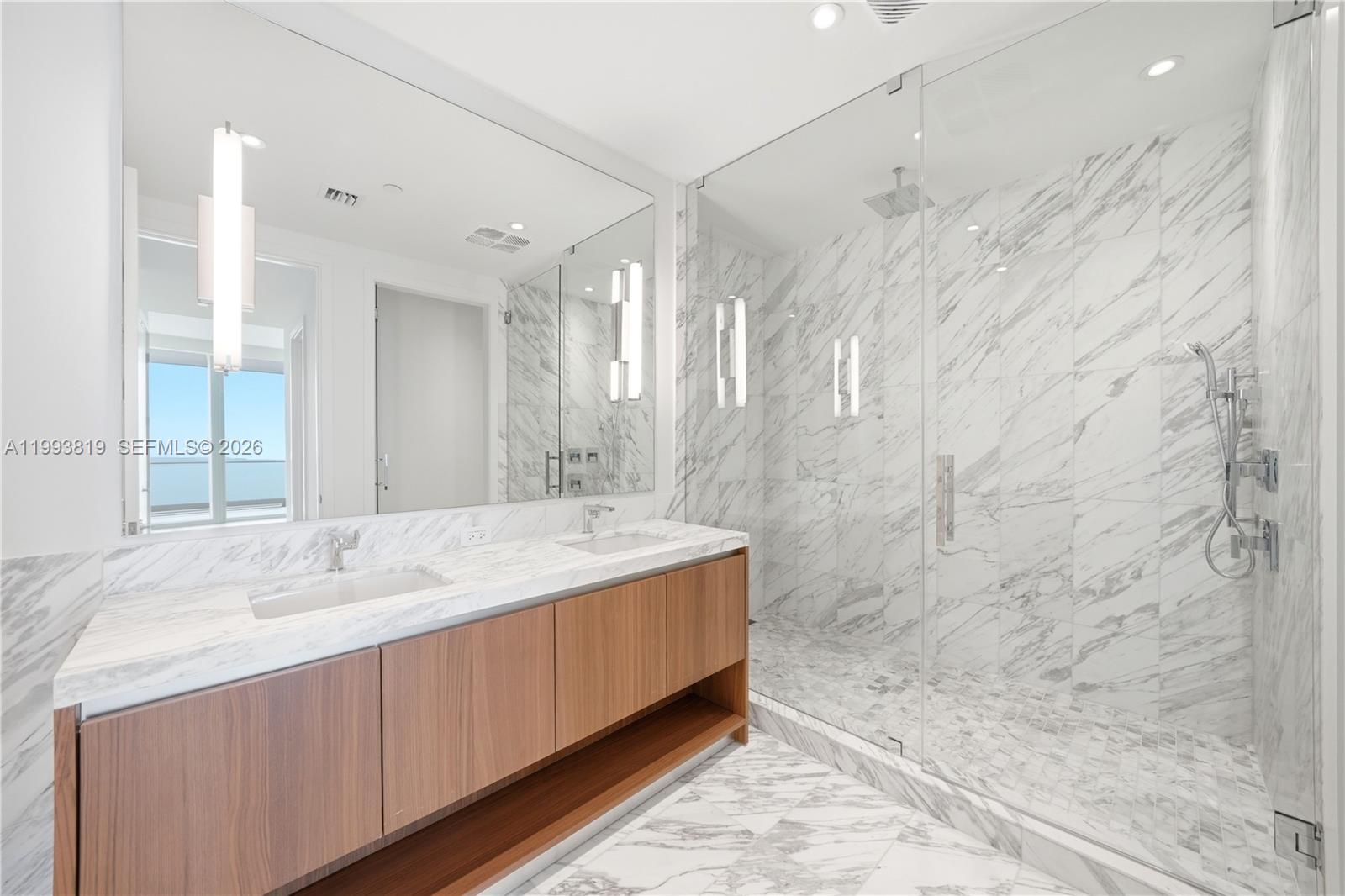175 Southeast 25th Road, Unit 3102 Miami, FL 33129 - Photo 18 of 65 a bathroom with a double vanity sink mirror and shower