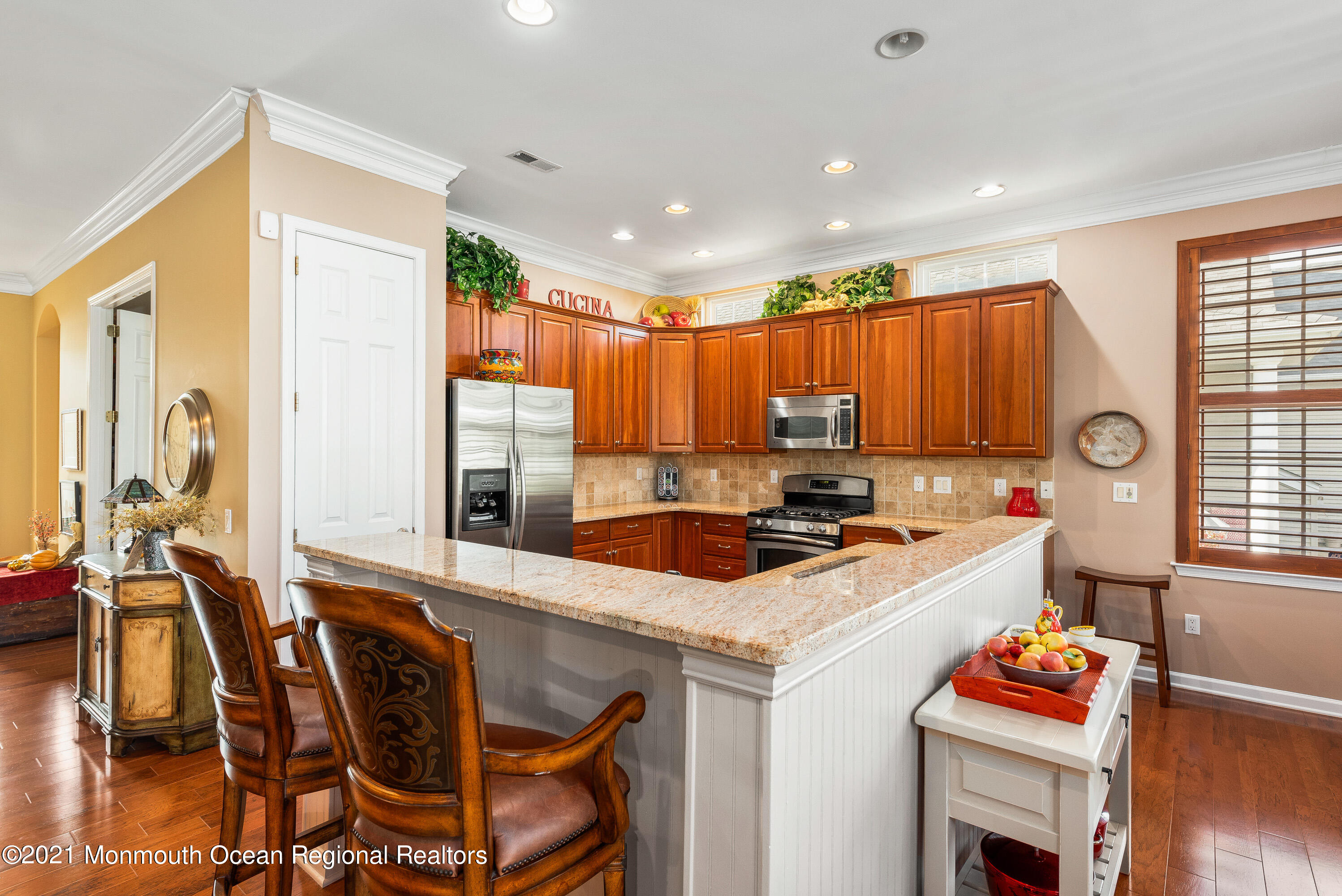 12 Muirfield Road Jackson, NJ 08527 - Photo 14 of 49 a kitchen with a stove a refrigerator and a dining table with wooden floor