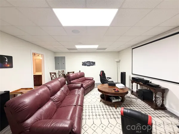 a living room with furniture a air conditioner and a window