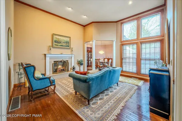 a view of a livingroom with wooden floor and furniture