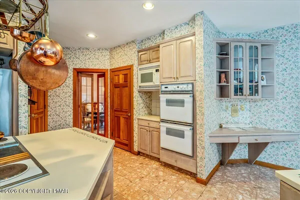 a kitchen with stainless steel appliances granite countertop a stove and a refrigerator