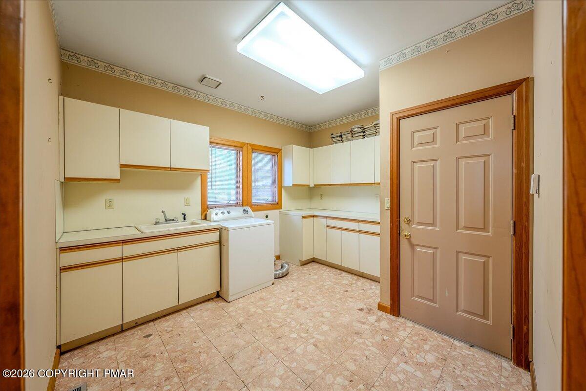 144 Ladderback Lane Cresco, PA 18326 - Photo 18 of 49 a kitchen with white cabinets and white appliances