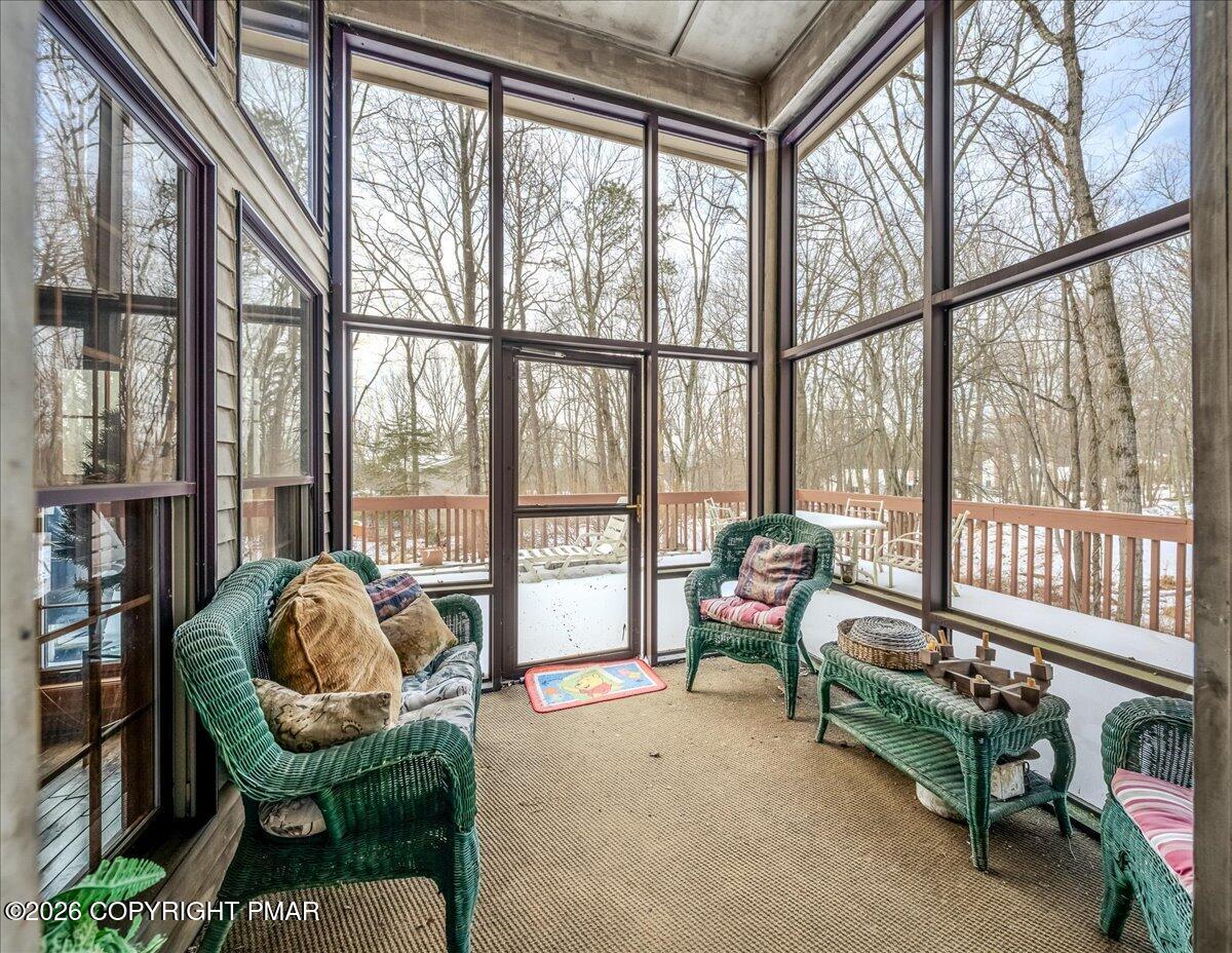 144 Ladderback Lane Cresco, PA 18326 - Photo 21 of 49 a living room with furniture and a floor to ceiling window