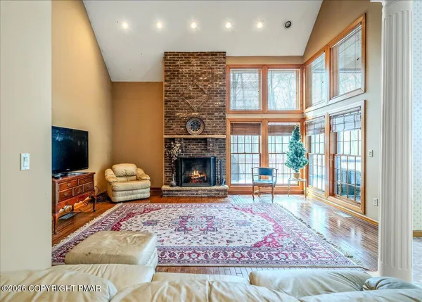 a living room with furniture and a floor to ceiling window
