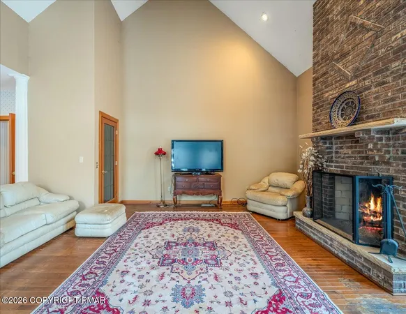 a living room with furniture rug and a fireplace