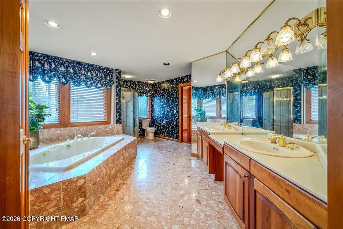 144 Ladderback Lane Cresco, PA 18326 - Photo 34 of 49 a spacious bathroom with a tub a double vanity sink a mirror and a shower