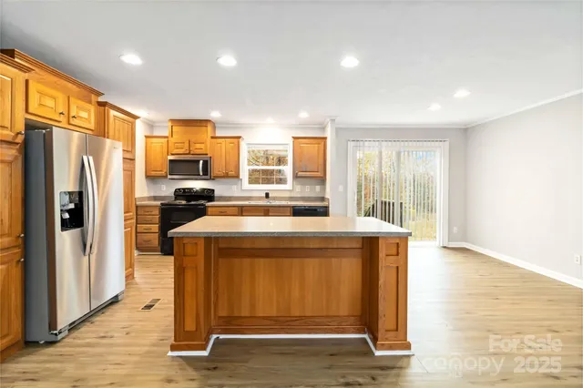 a kitchen with stainless steel appliances a stove a refrigerator and a refrigerator