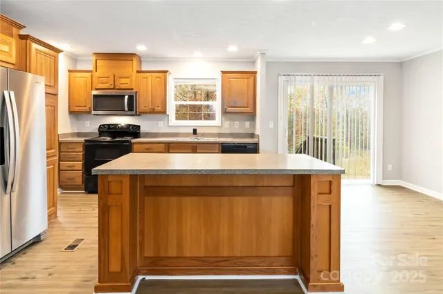 a kitchen with a refrigerator and a stove top oven