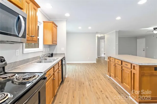 a kitchen with stainless steel appliances granite countertop a stove and a sink